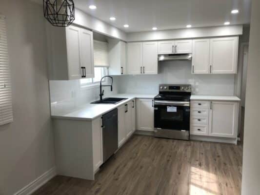 Small kitchen with shaker-style white cabinets